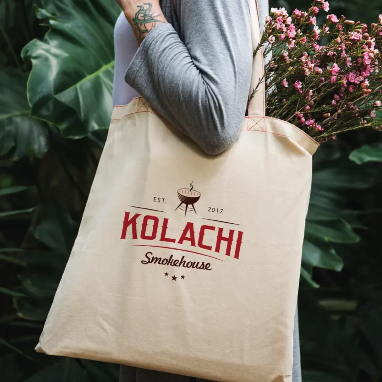 Woman carrying a Kolachi branded tote bag